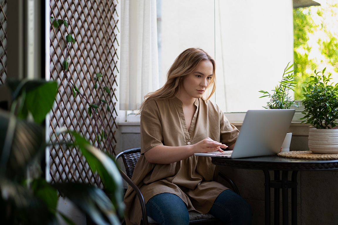 Woman managing office via laptop, using the Good Monday Platform